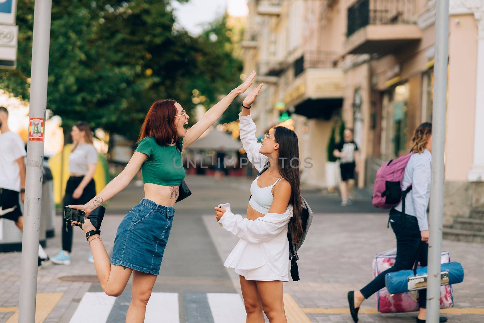 Two students high five to teach others after successful work together by teksomolika