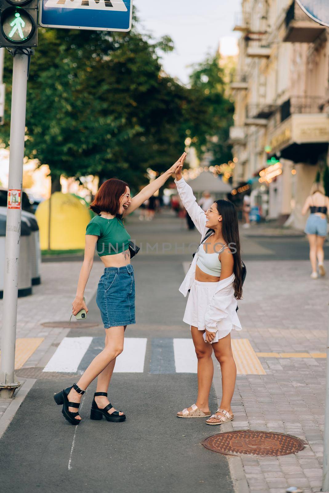 Two University students high five to teach others after successful work together