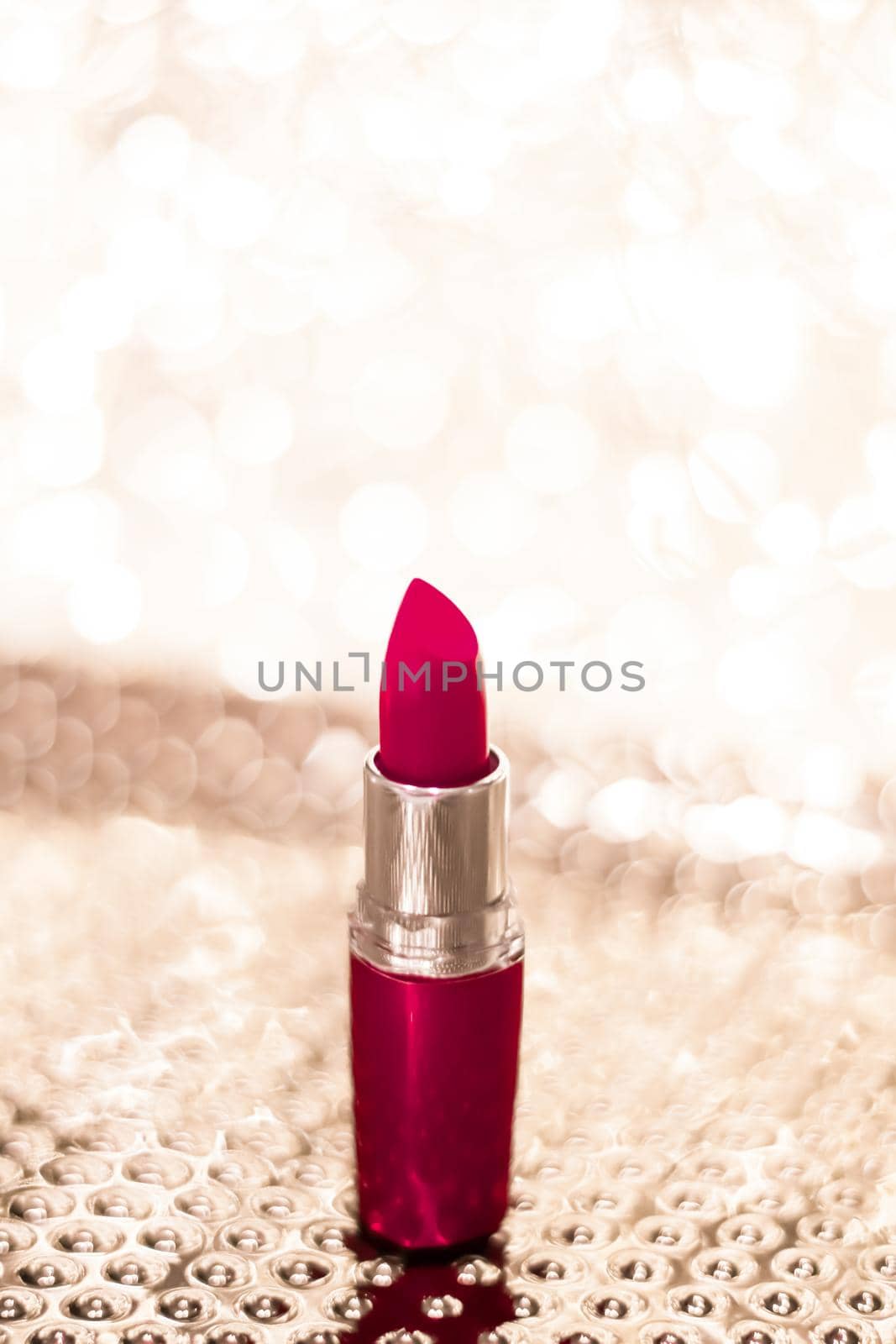 Cosmetic branding, sale and glamour concept - Maroon lipstick on golden Christmas, New Years and Valentines Day holiday glitter background, make-up and cosmetics product for luxury beauty brand