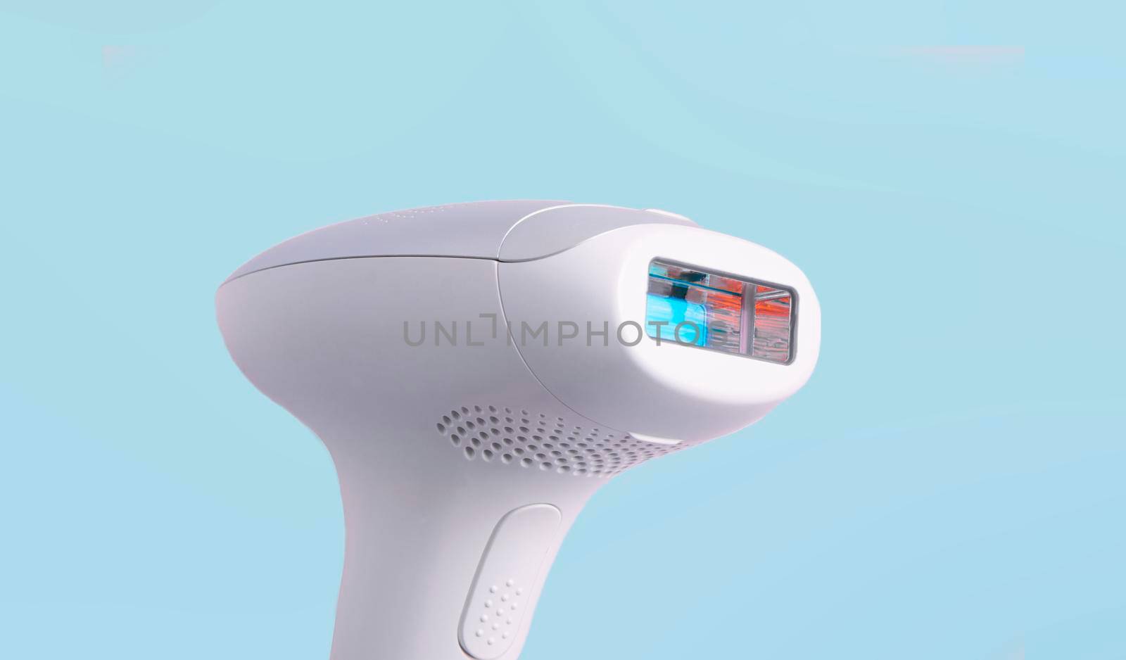 home modern laser epilator. Hair Remover offering Permanently Smooth Skin. Flash Epilator Laser on a pink background. Female blog concept. Photoepilator for home use. selective focus. close-up.