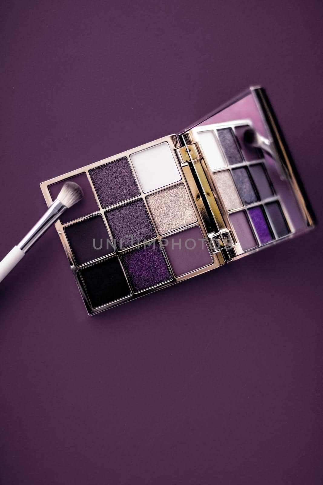 Cosmetic branding, mua and girly concept - Eyeshadow palette and make-up brush on purple background, eye shadows cosmetics product as luxury beauty brand promotion and holiday fashion blog design