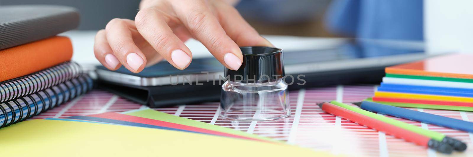 Close-up of designer person searching for perfect shadow of colour using magnifying glass tool. Work on project for interior design. Art, agency concept