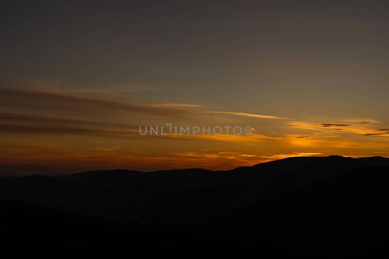 Sunset in mountains in summer landscape.