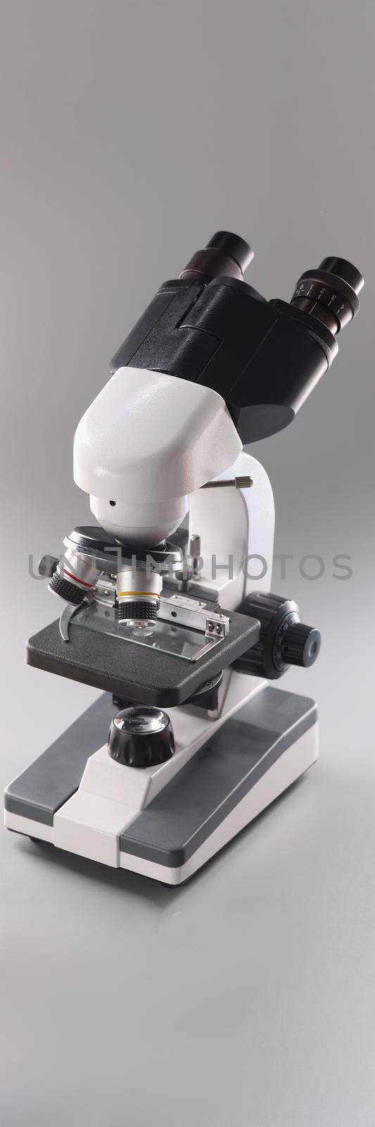 Close-up of modern microscope tool for laboratory research, magnifying device for precise results of research or experiment. Scientific appliance concept