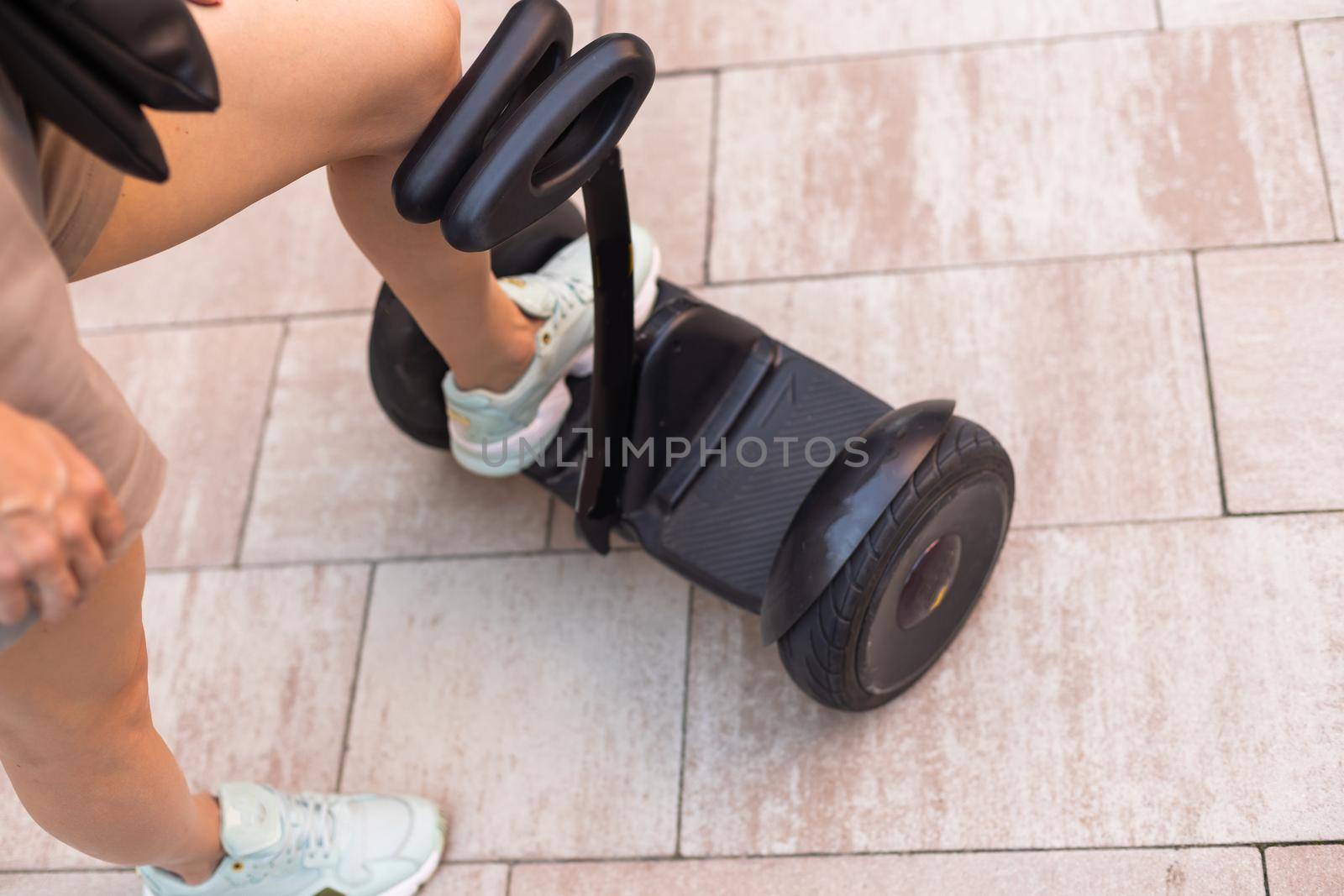 Beautiful woman stand near segway or hoverboard. self balancing electrical scooter. by Andelov13