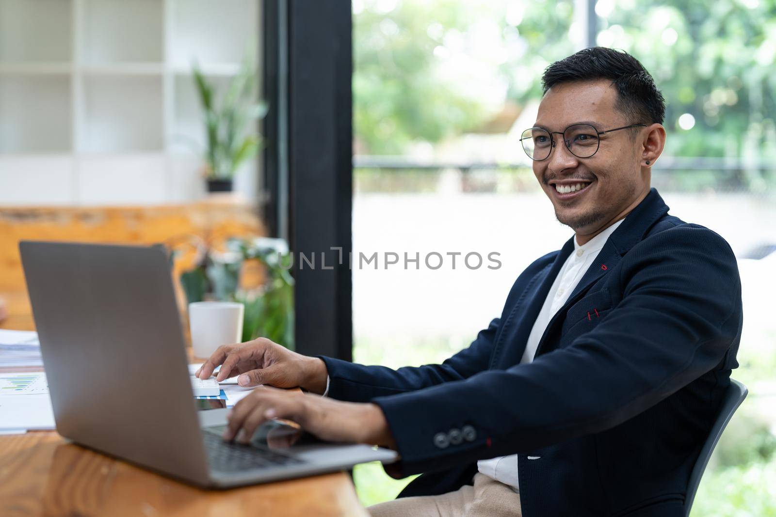Portrait of a business man using laptop computer at office