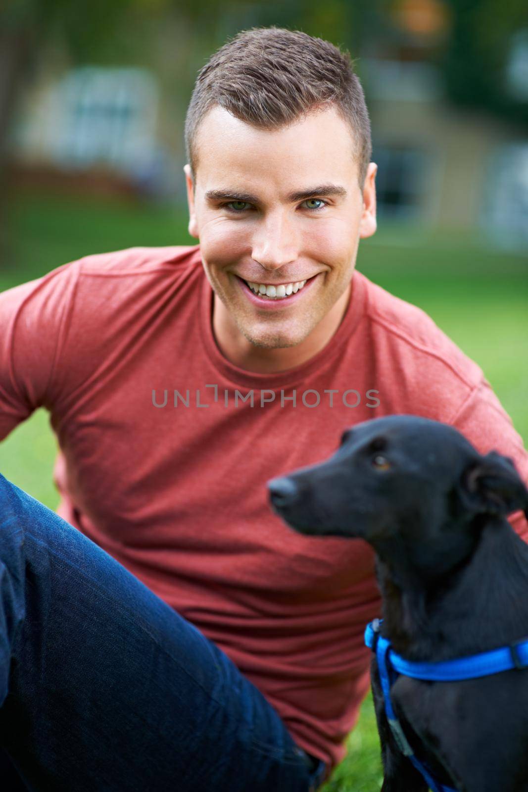Hes my best friend. A young man playing with his dog outdoors