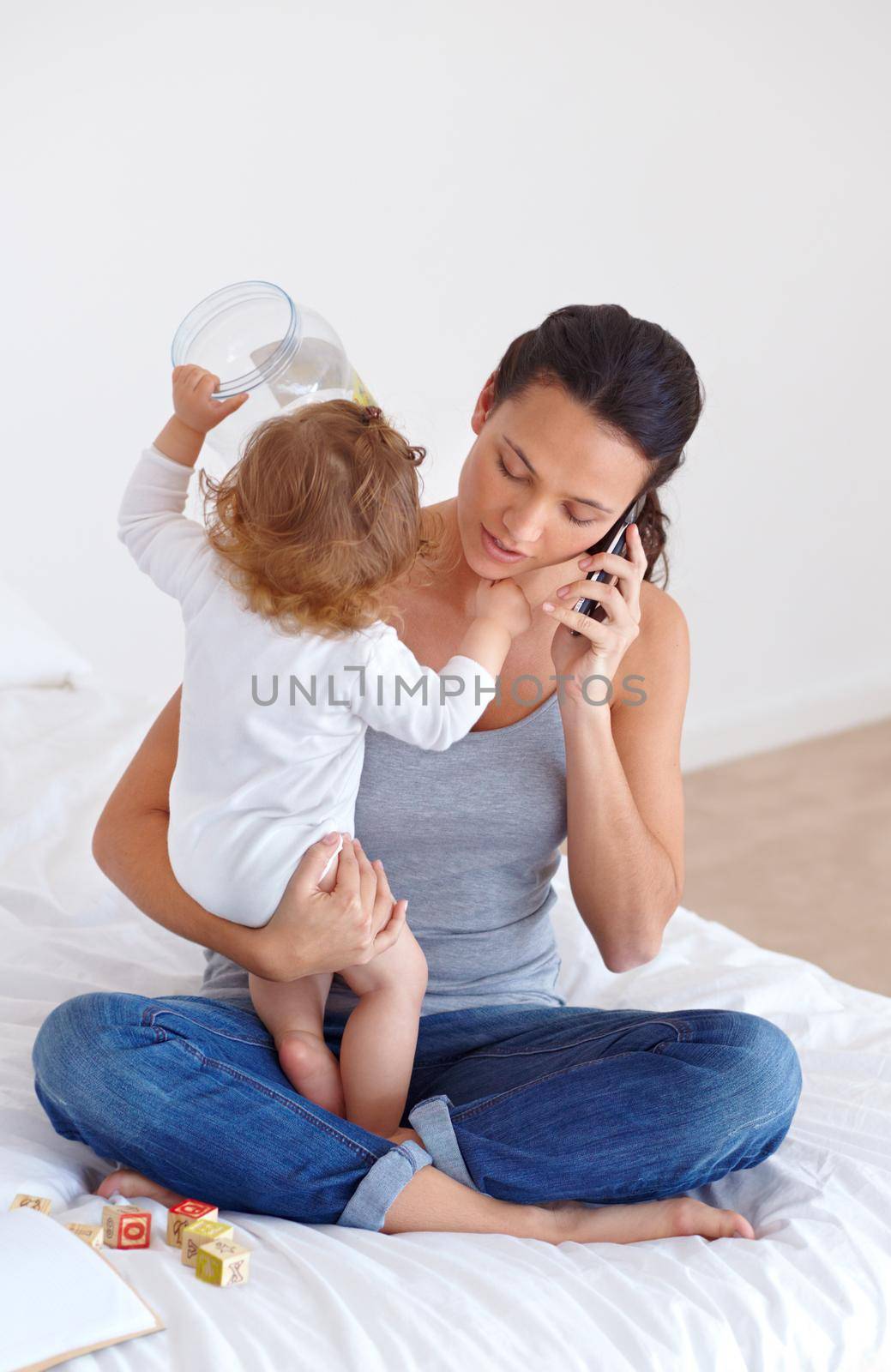 Trying to balance it all - Motherhood. a beautiful young woman and her baby at home