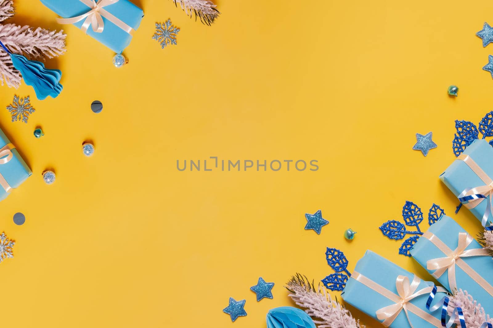 Christmas flat lay composition from gifts, paper balls and tinsel top view. Ukrainian yellow blue colors. Copy space by ssvimaliss