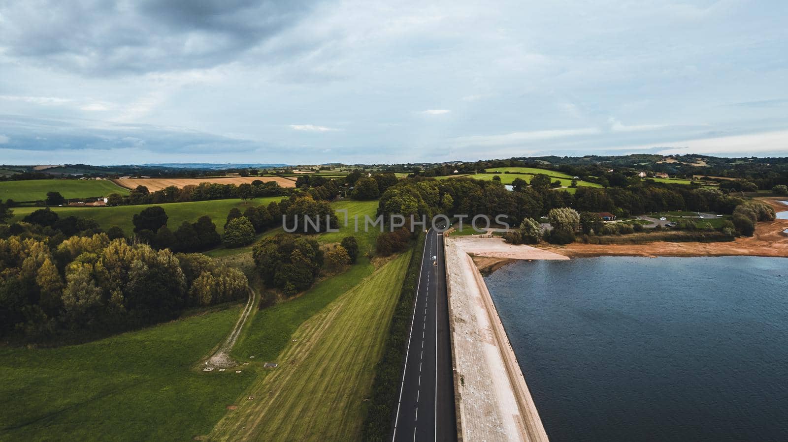 Aerial view from road between lake and land . High quality photo