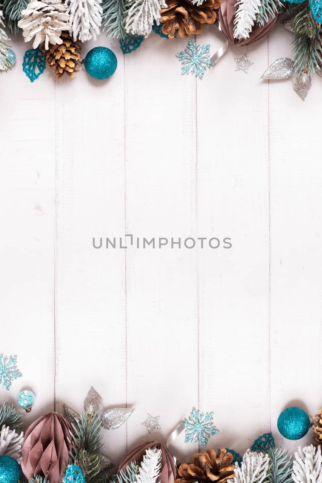 Vertical Christmas flat lay composition from pine, cones, balls on wooden background top view. Copy space.