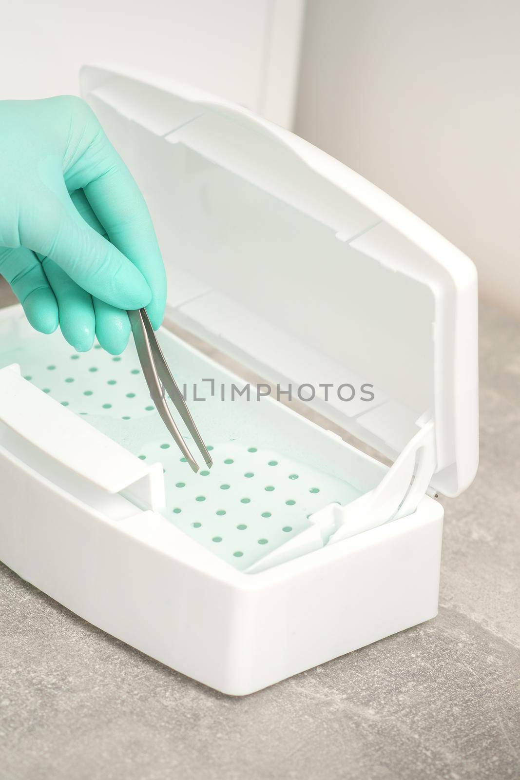 Hand disinfects tweezers with cleaning systems for medical instruments. Ultrasonic cleaner