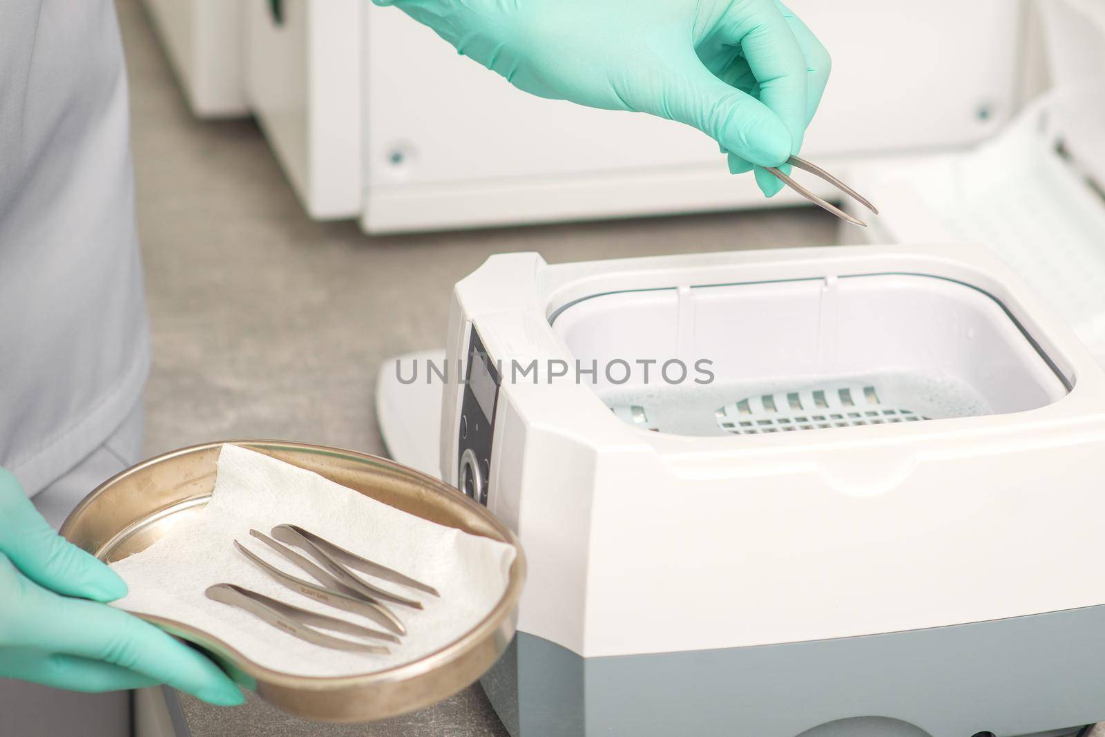 Hand disinfects tweezers with cleaning systems for medical instruments. Ultrasonic cleaner. by okskukuruza