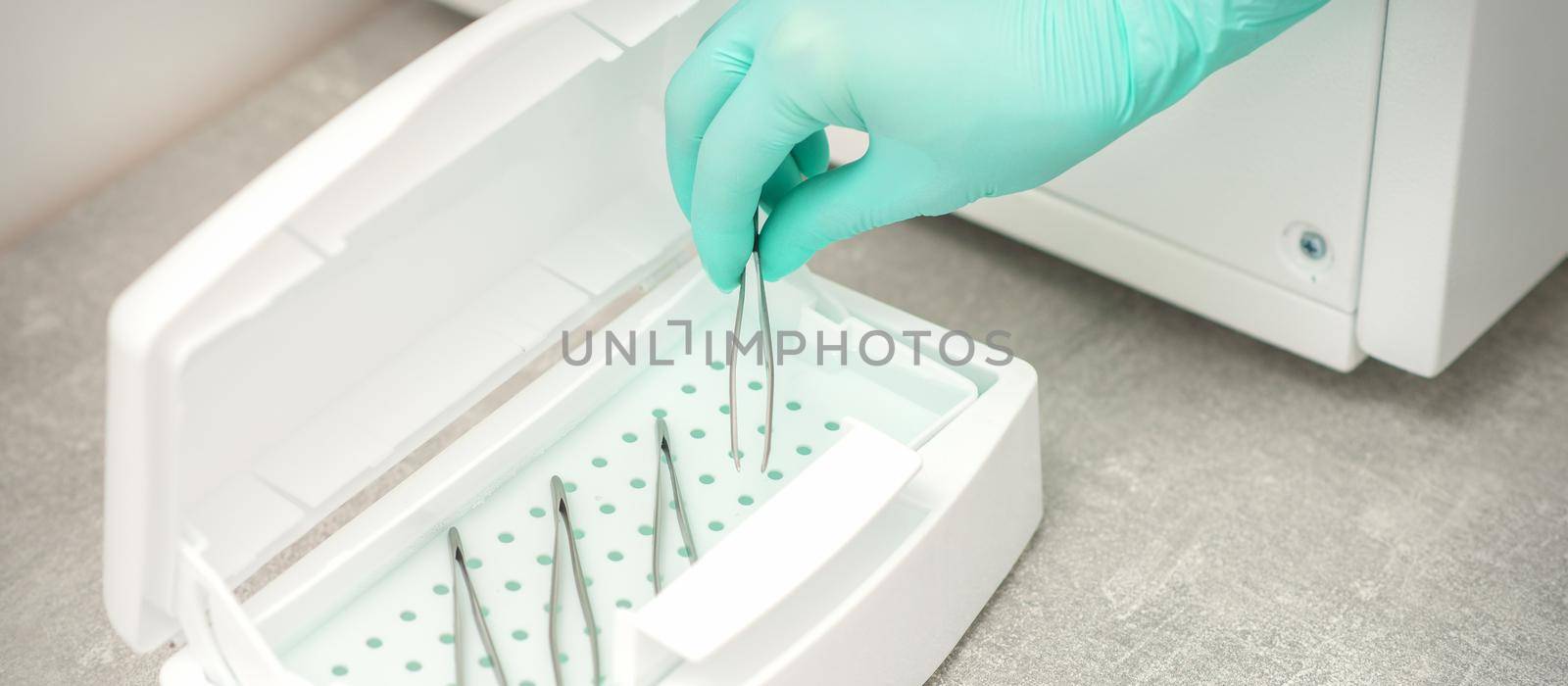 Hand disinfects tweezers with cleaning systems for medical instruments. Ultrasonic cleaner