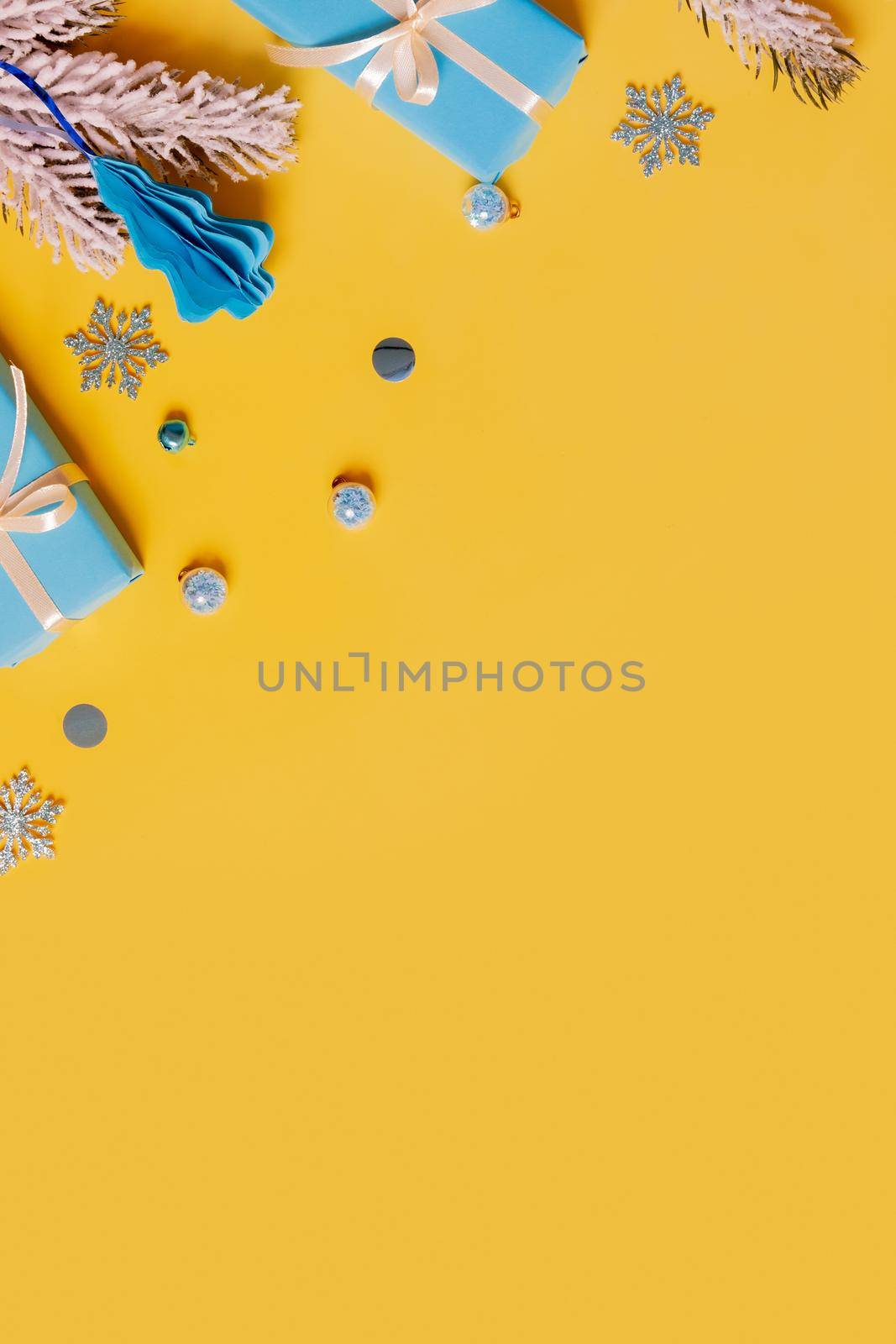 Christmas flat lay composition from gifts, paper balls and tinsel top view. Ukrainian yellow blue colors. Copy space.