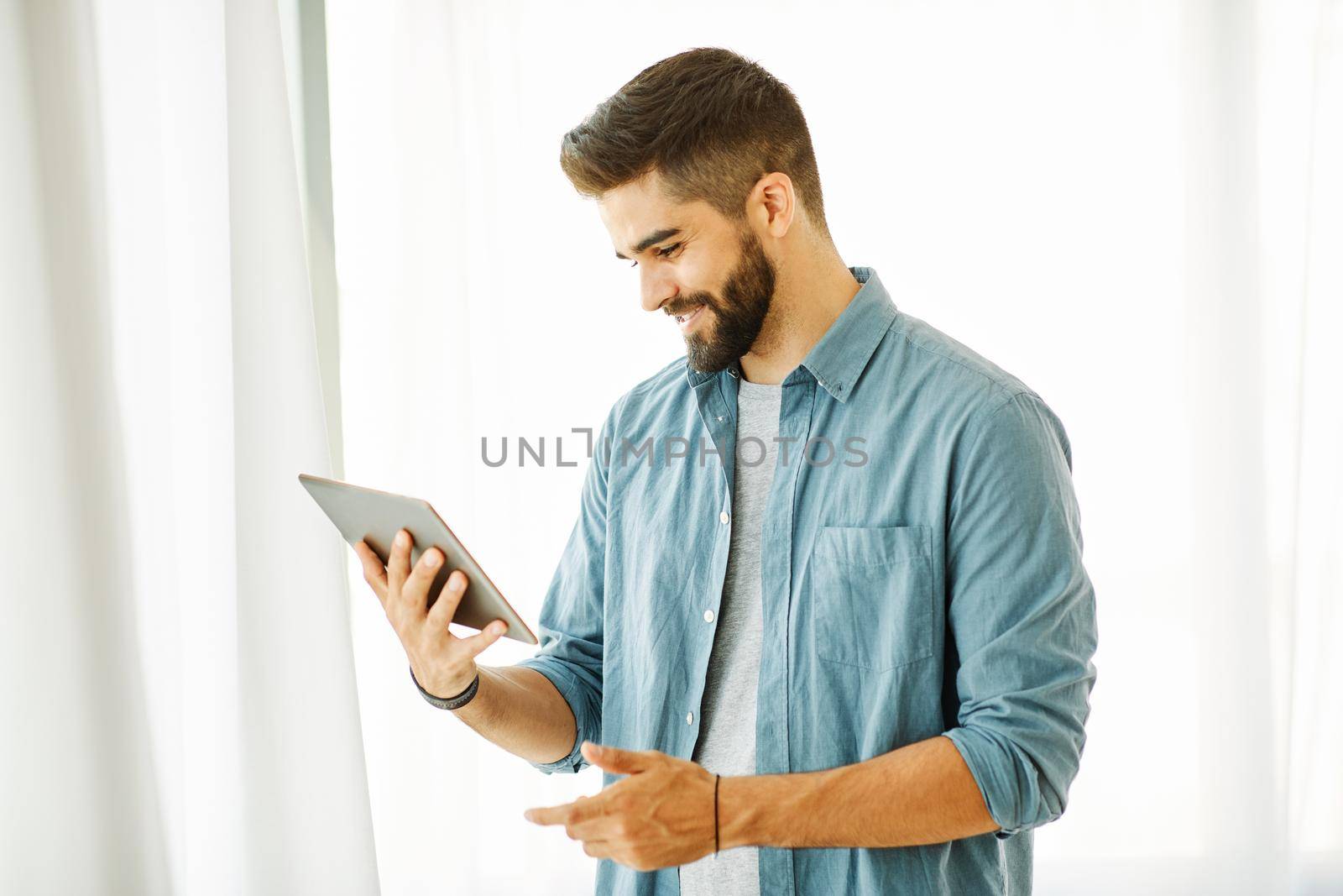 Portrait of a young man with a tablet