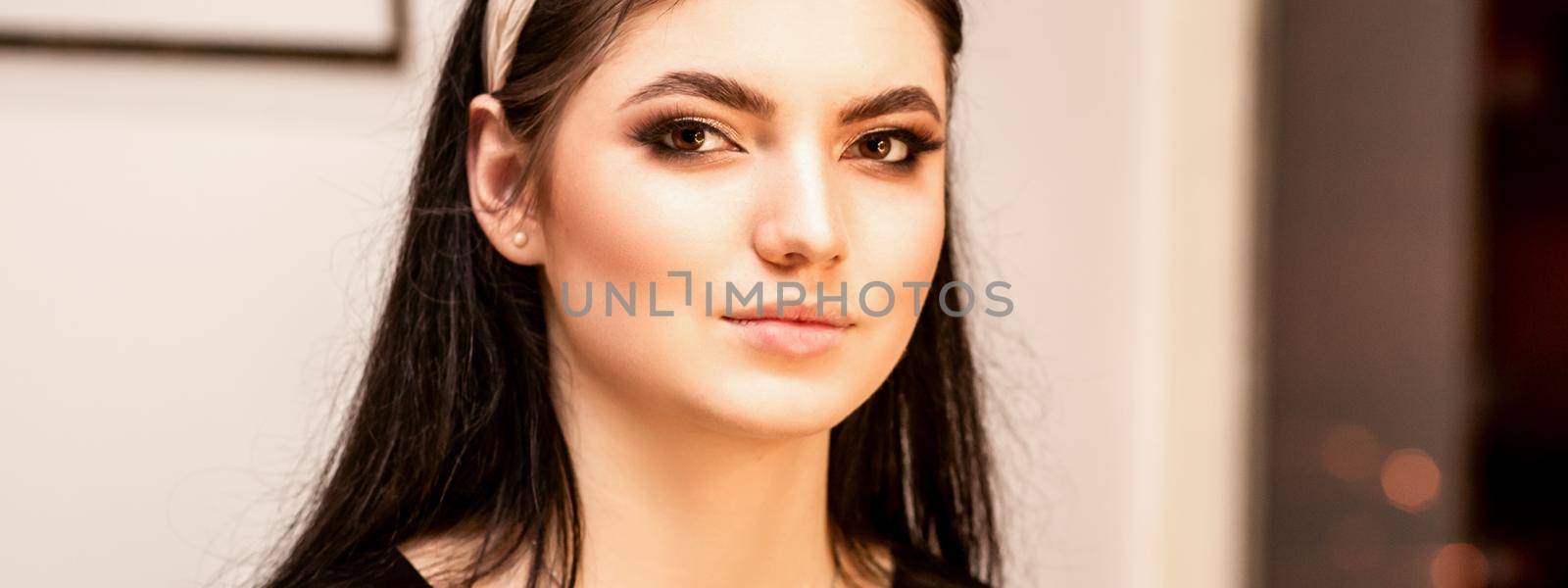 The fashionable young woman. Portrait of the beautiful female model with long hair and makeup. Beauty young caucasian woman with a hoop on her head. by okskukuruza