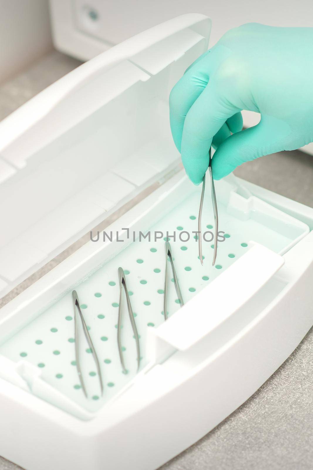 Hand disinfects tweezers with cleaning systems for medical instruments. Ultrasonic cleaner. by okskukuruza
