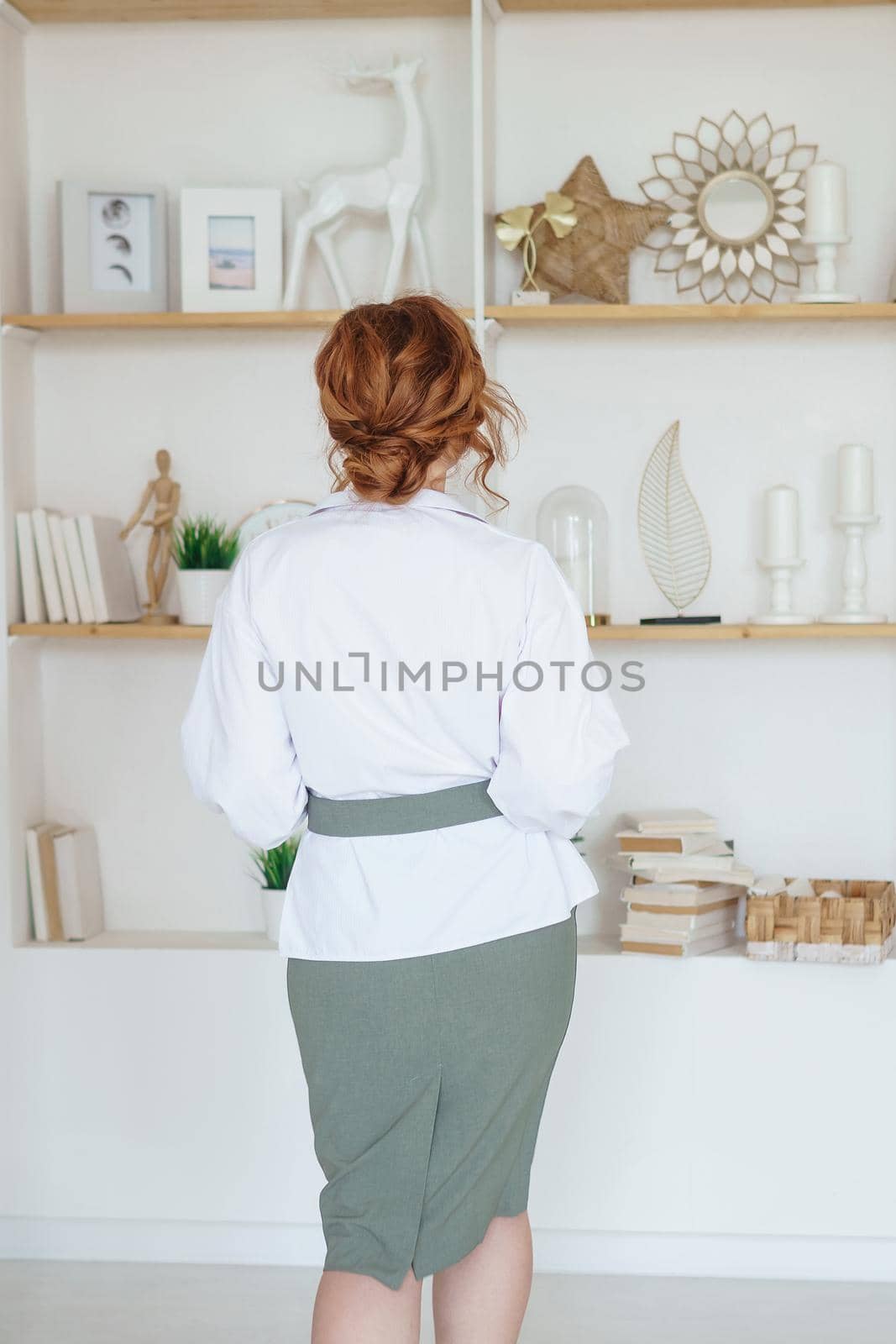 Tver, Russia-July 31, 2022 A business woman with a book on Human Design in her hands. A human design specialist works at home. Working at home during the epidemic.