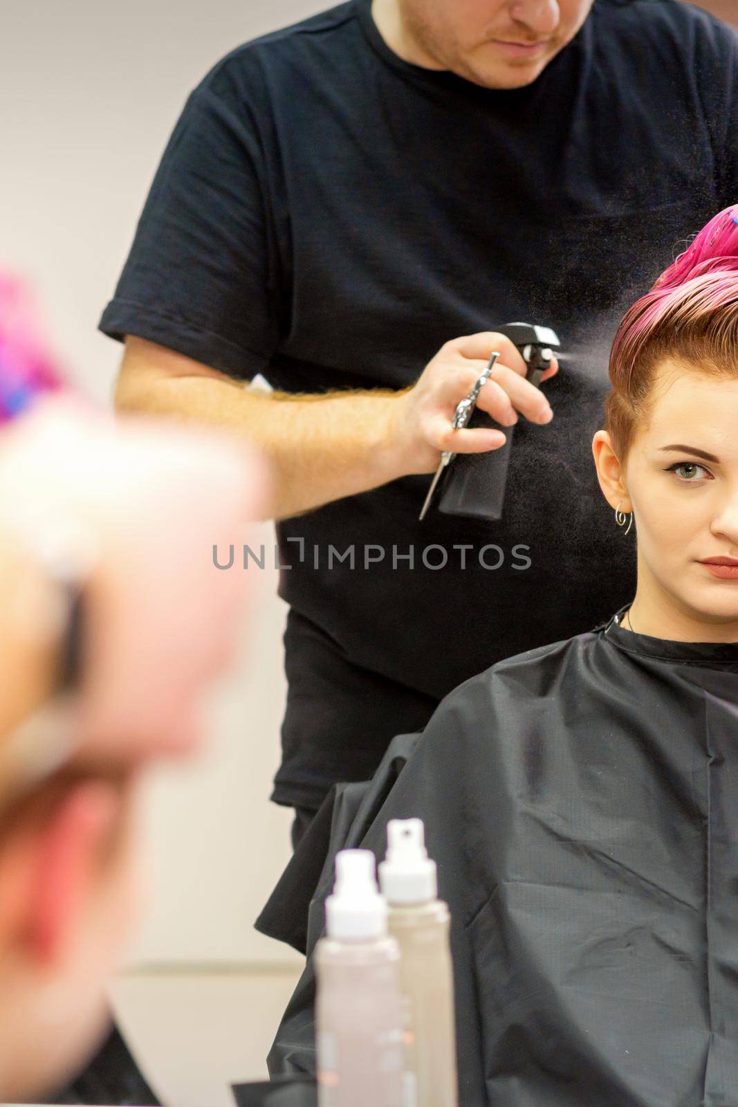 Beautiful young pink haired caucasian woman in the modern hair salon