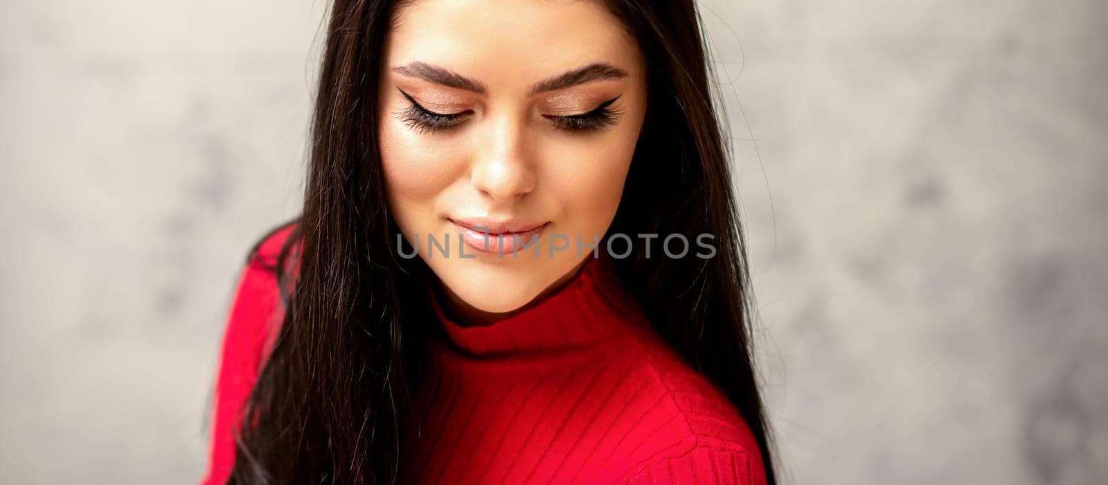 The fashionable young woman. Portrait of the beautiful female model with long hair and makeup with eyelash extensions. Beauty young caucasian woman with a black hairstyle. by okskukuruza