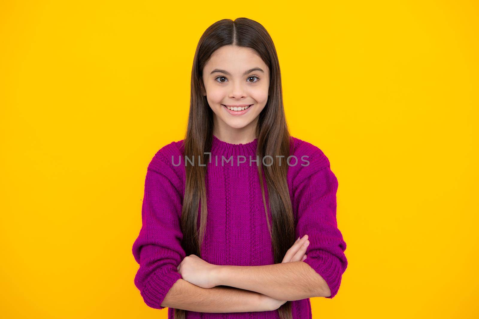 Pretty teen girl headshot portrait. Adorable little girl child isolated on a yellow background