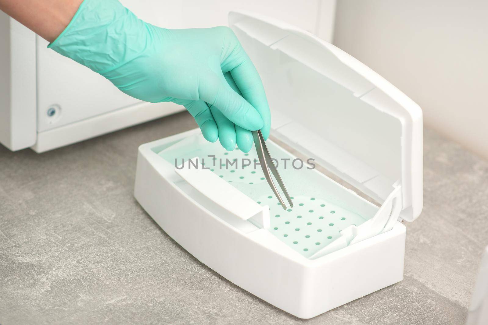 Hand disinfects tweezers with cleaning systems for medical instruments. Ultrasonic cleaner. by okskukuruza