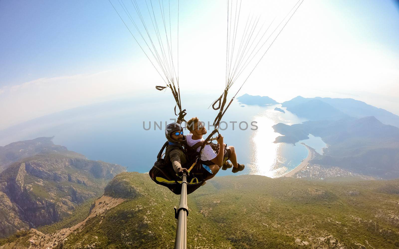 Paragliding in Fethiye, Turkey Paraglider flying above Oludeniz beach in Fethiye Turkey during sunset.