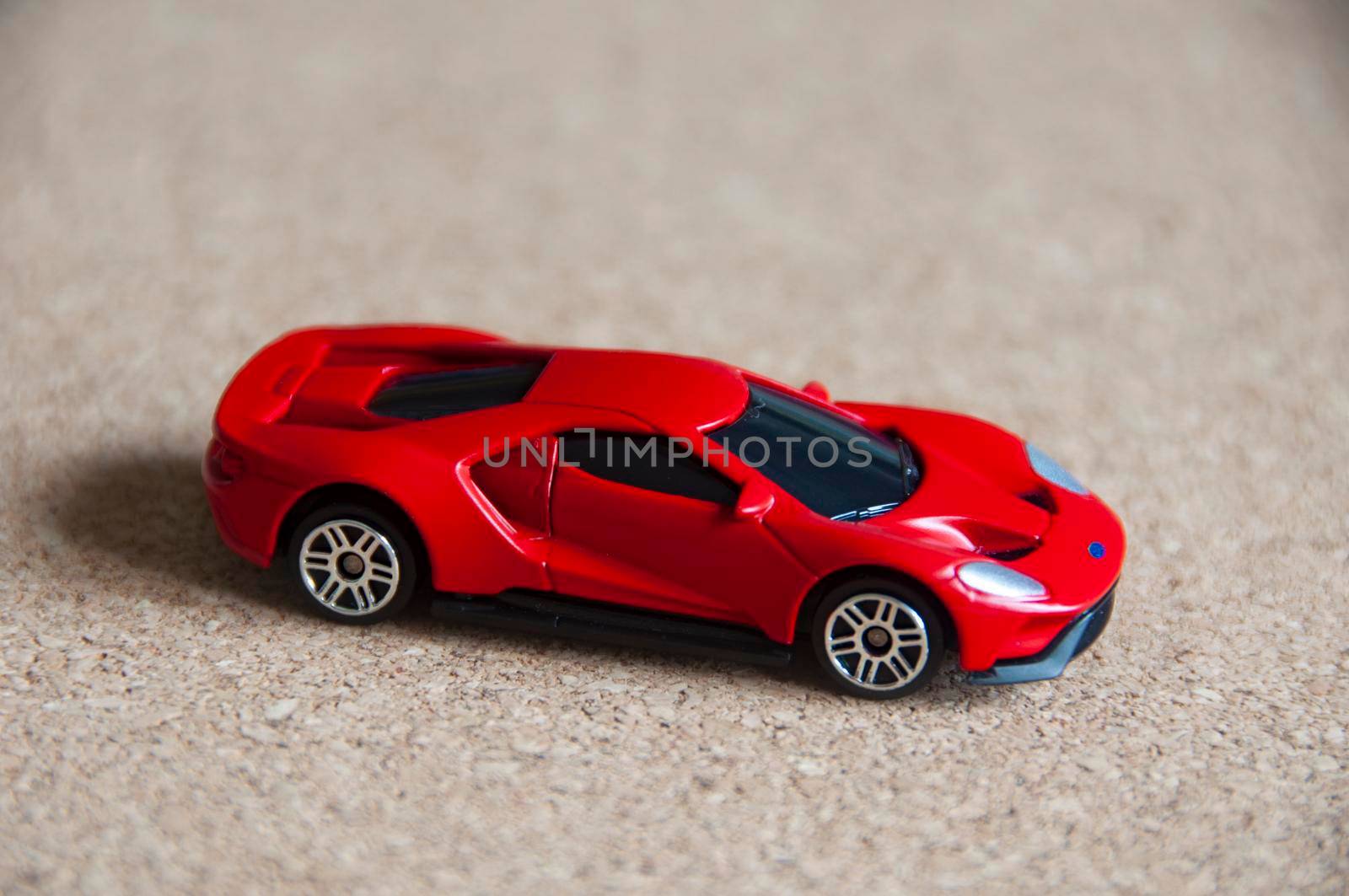 Kuala Lumpur, Malaysia - September 2022 : Selective focus of miniature toy car of Ford GT on wooden cover background. Copy space.