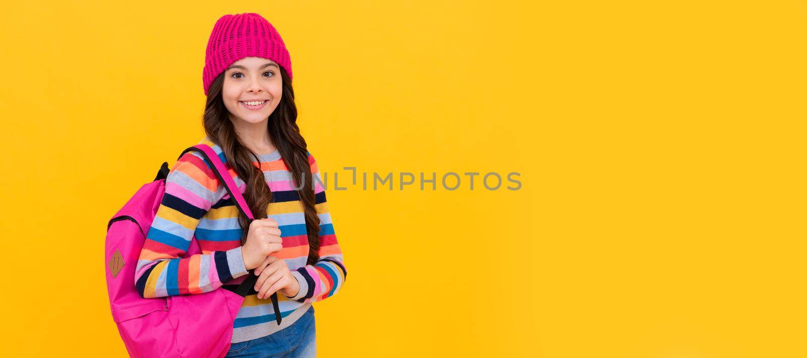 happy hipster teen girl with backpack going to school, chilshood. Portrait of schoolgirl student, studio banner header. School child face, copyspace. by RedFoxStudio