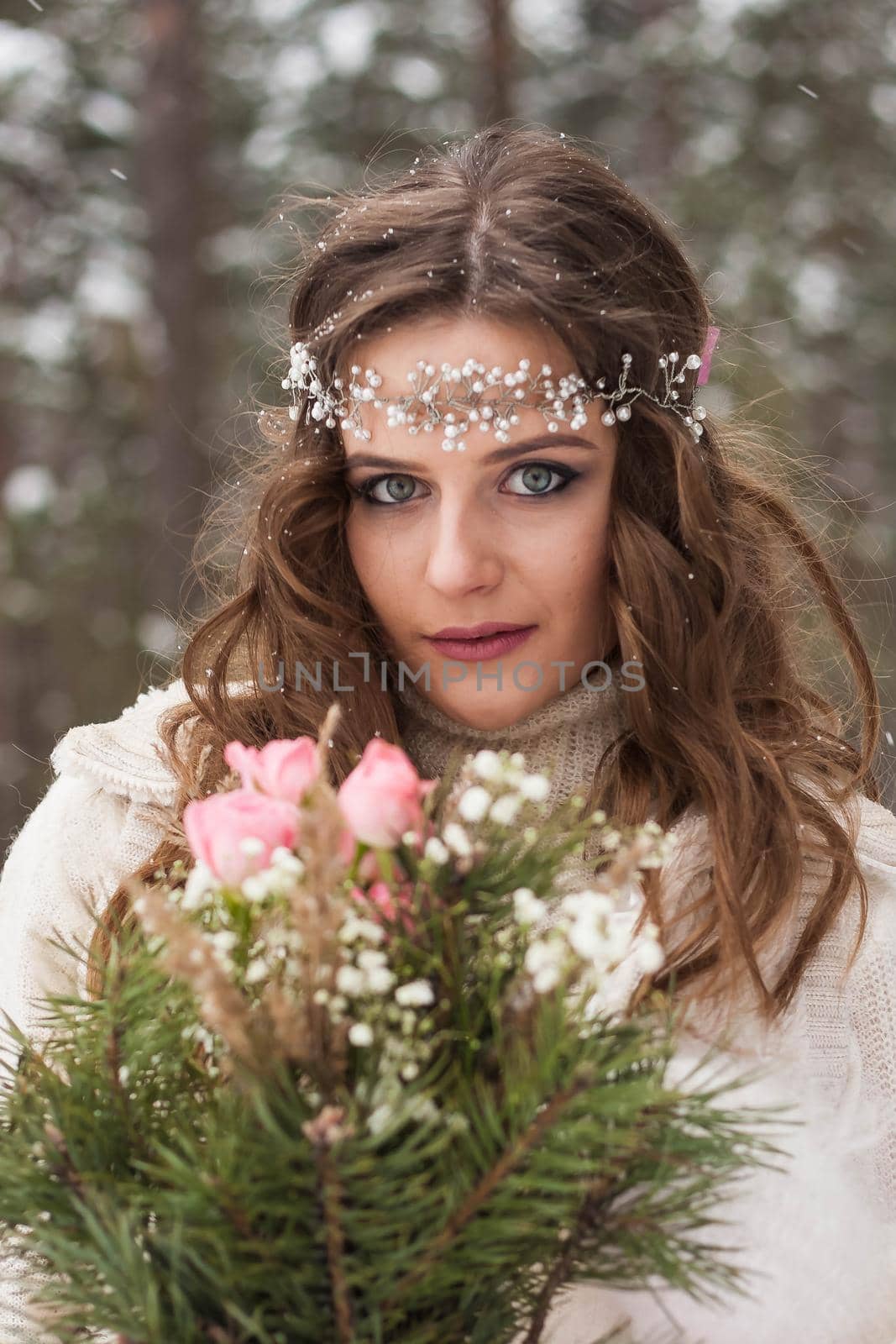 Beautiful bride in a white dress with a bouquet in a snow-covered winter forest. Portrait of the bride in nature by Annu1tochka