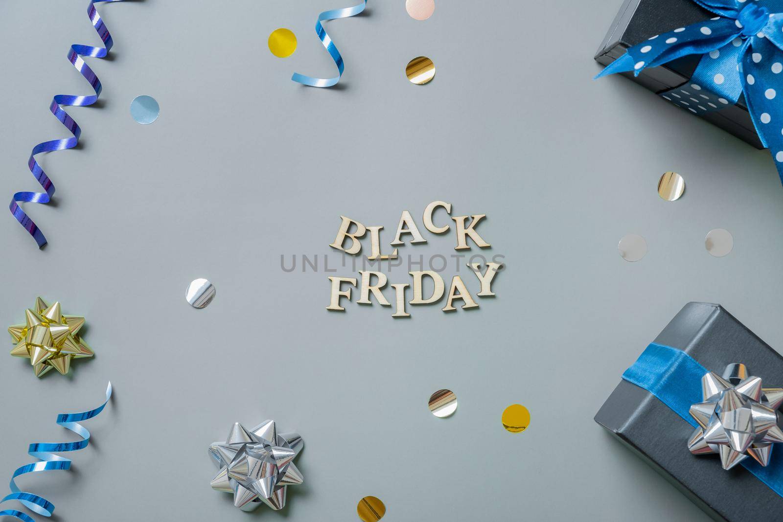 Black friday text with gifts and festive tinsel flat lay by ssvimaliss