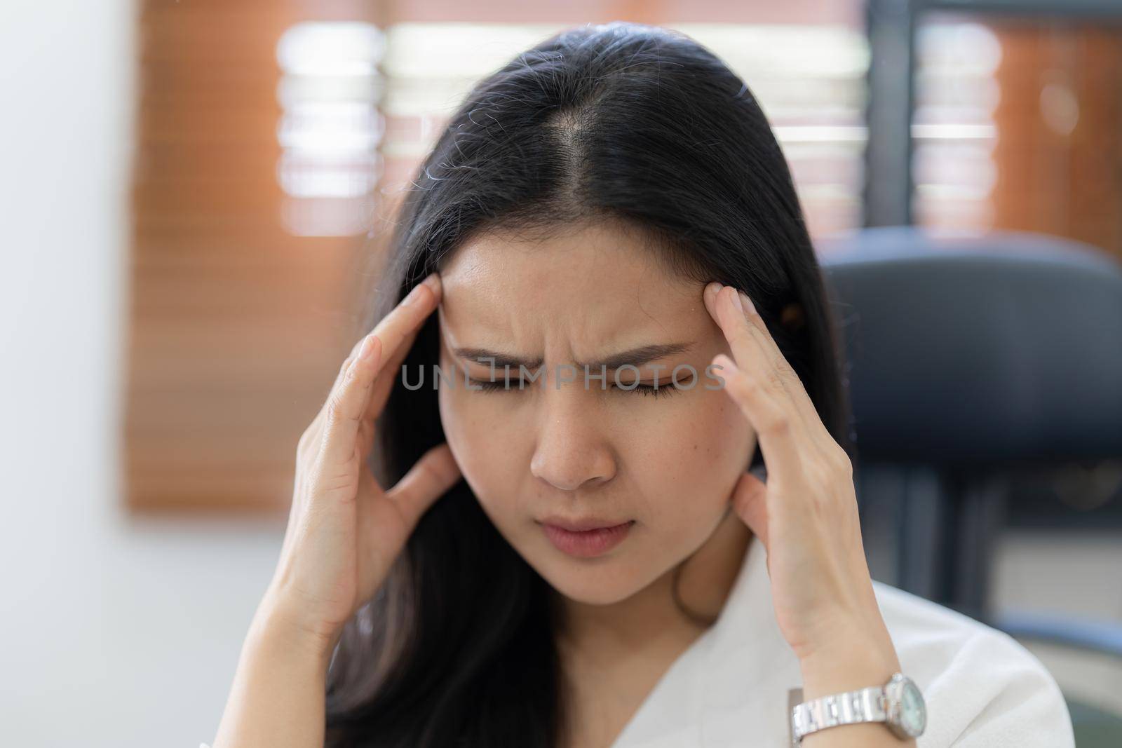 Portrait of stressed asian businesswoman in the office. burnout syndrome or deadline project concept.