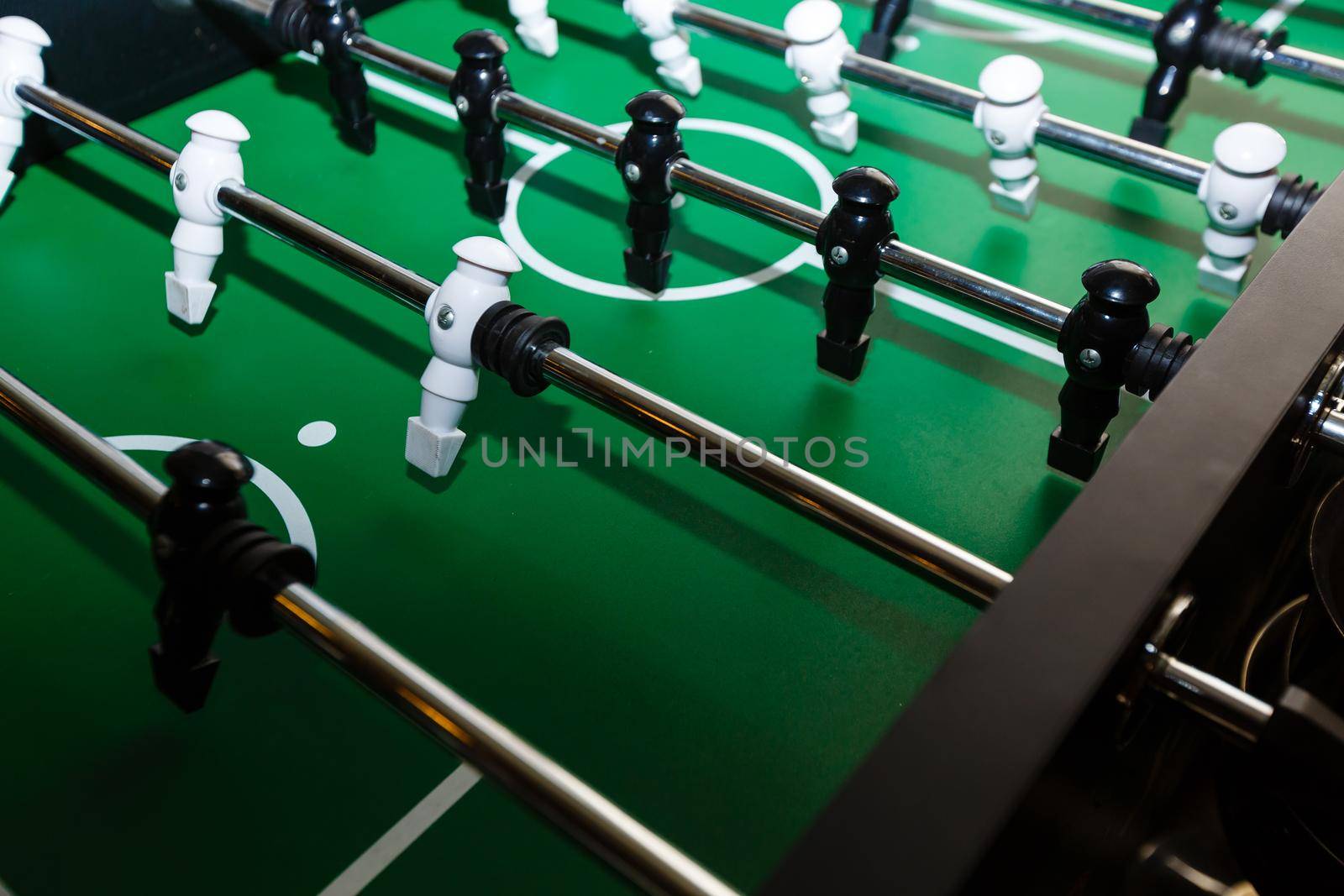 Table football in the entertainment center. Close-up image of plastic players in a football game by Andelov13