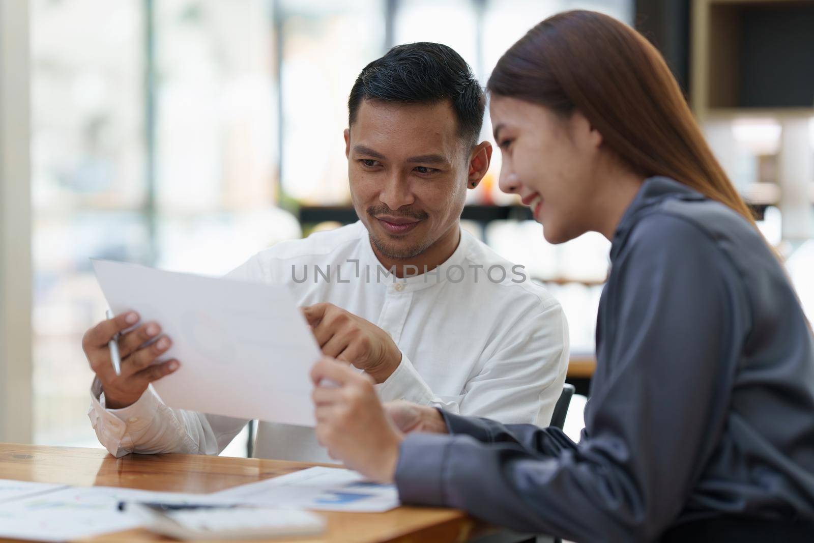 Two asian fund manager brainstorming new business project finance investment concept.