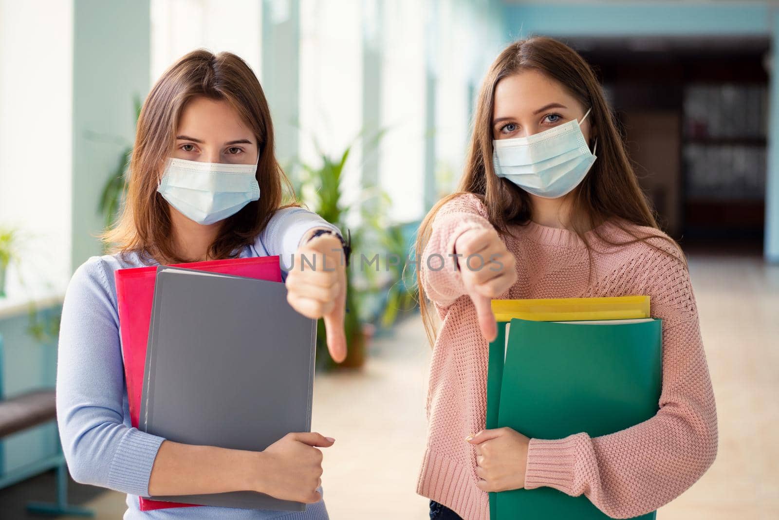 Students sick and tired of safety rules and wearing medical masks while education during Covid-19 pandemic