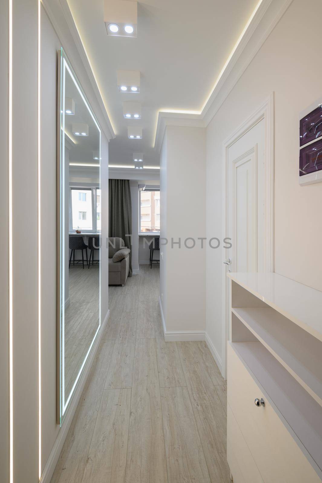 White long narrow hallway with a mirror by starush