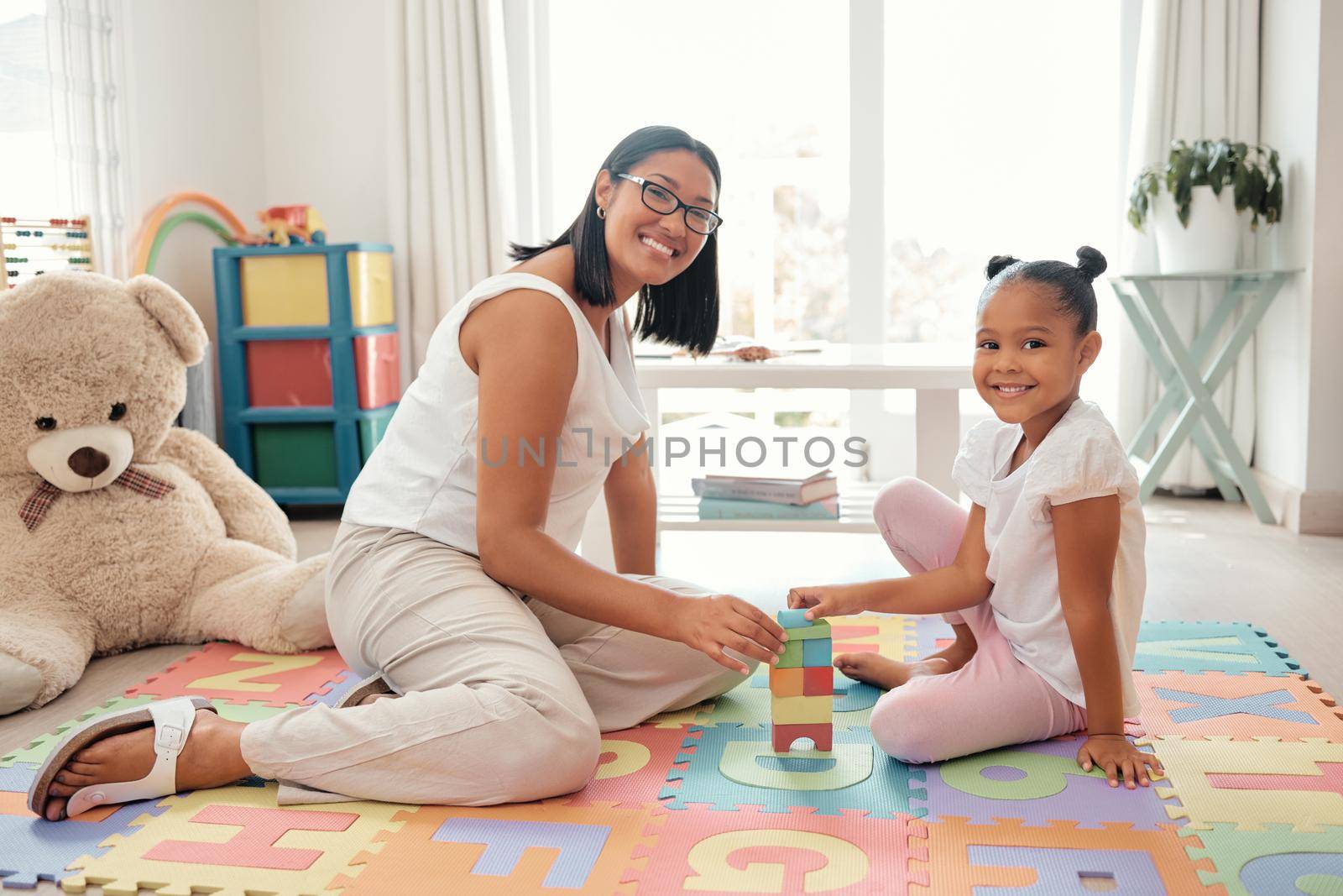 Mother, learning and child toy in home of knowledge development and education in a bedroom. Portrait of a happy family smile play a education game to build balance and children motor skills at home.