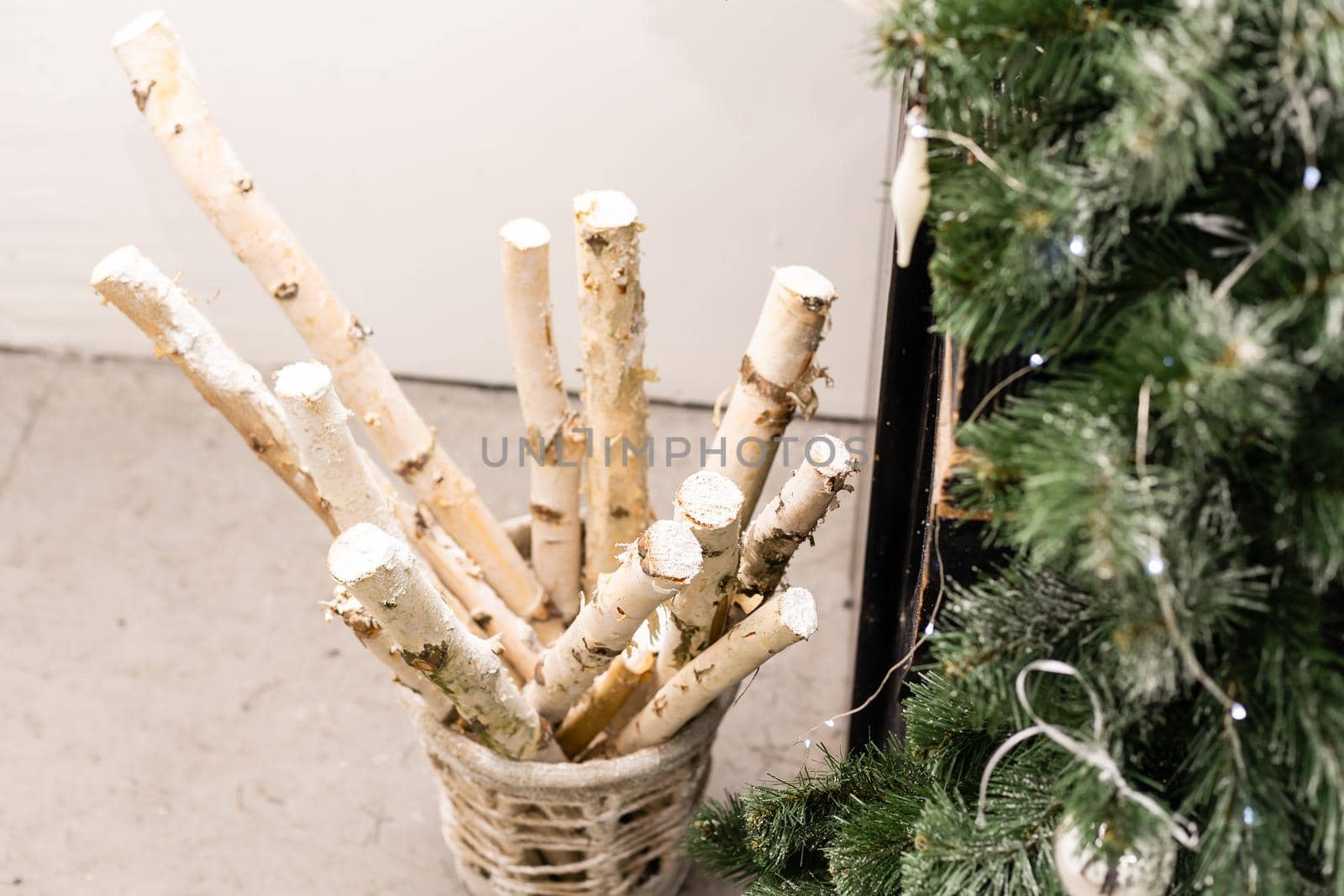 New Year decor of the Christmas tree. Wooden box with birch logs, decorated