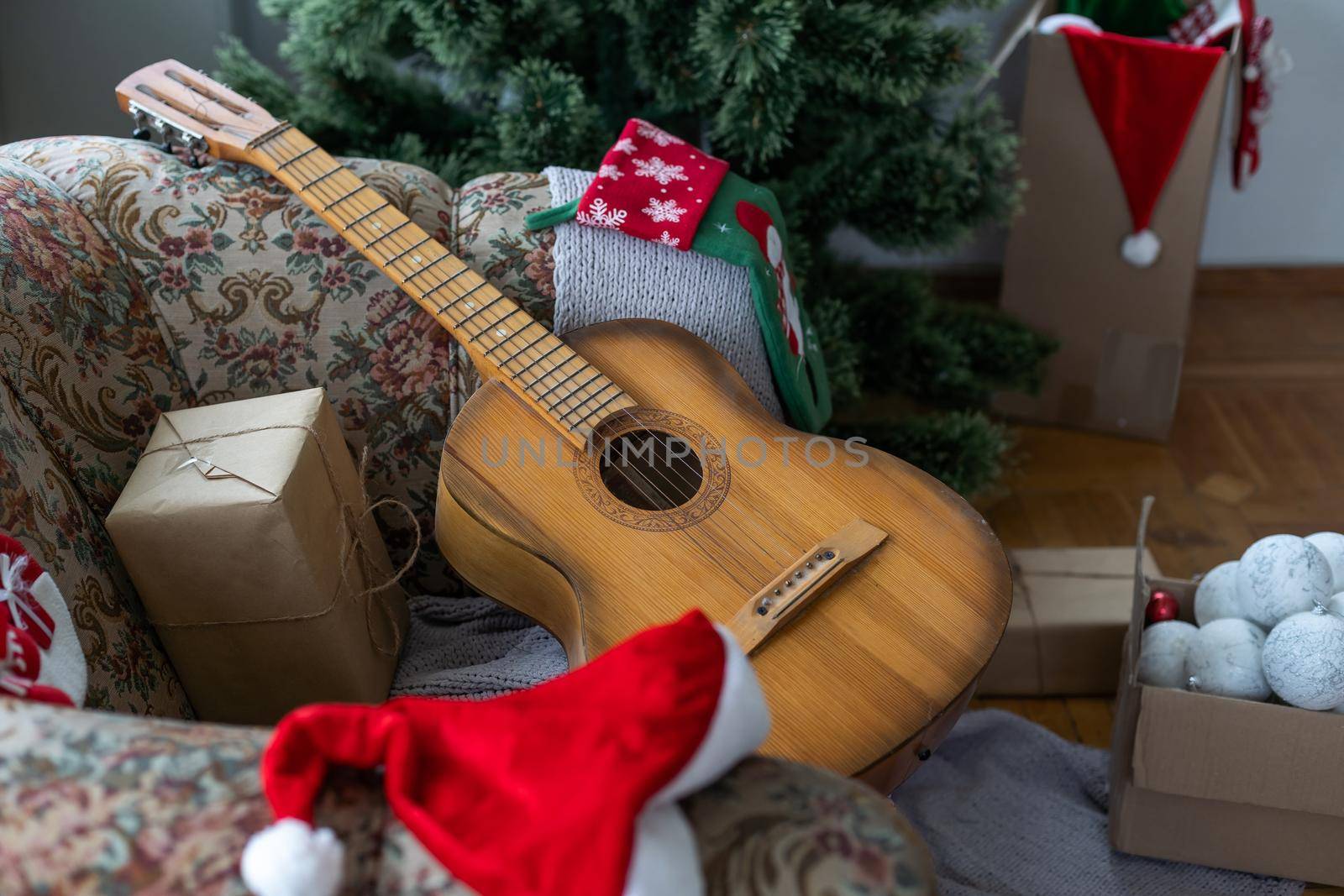 Guitar with decorated Christmas Tree in the background by Andelov13