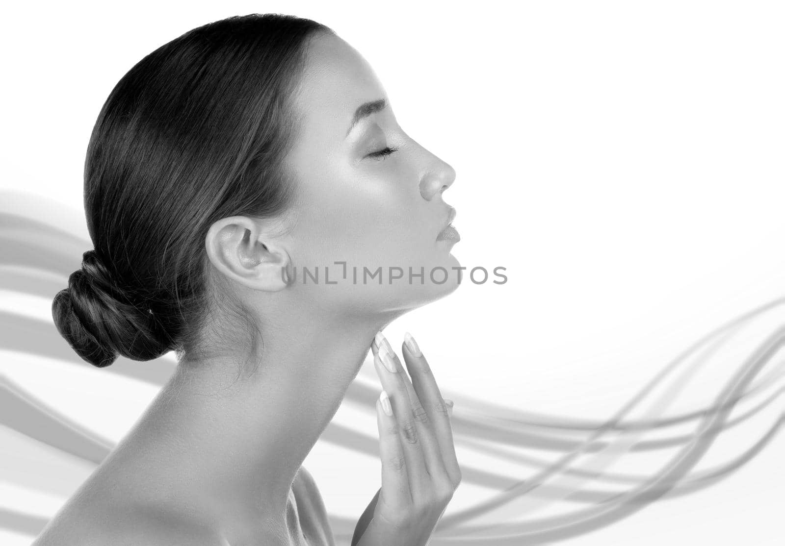 Pretty woman touching her neck against an abstract background