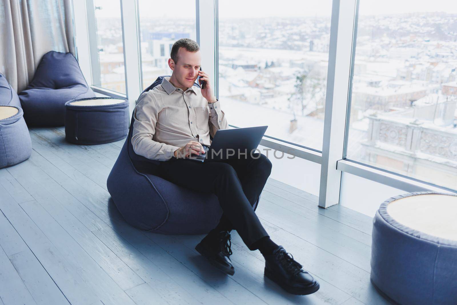 Young smart male businessman is sitting in the office and working on a project related to public cyber technology. Businessmen with laptop trying to meet deadlines in external marketing.