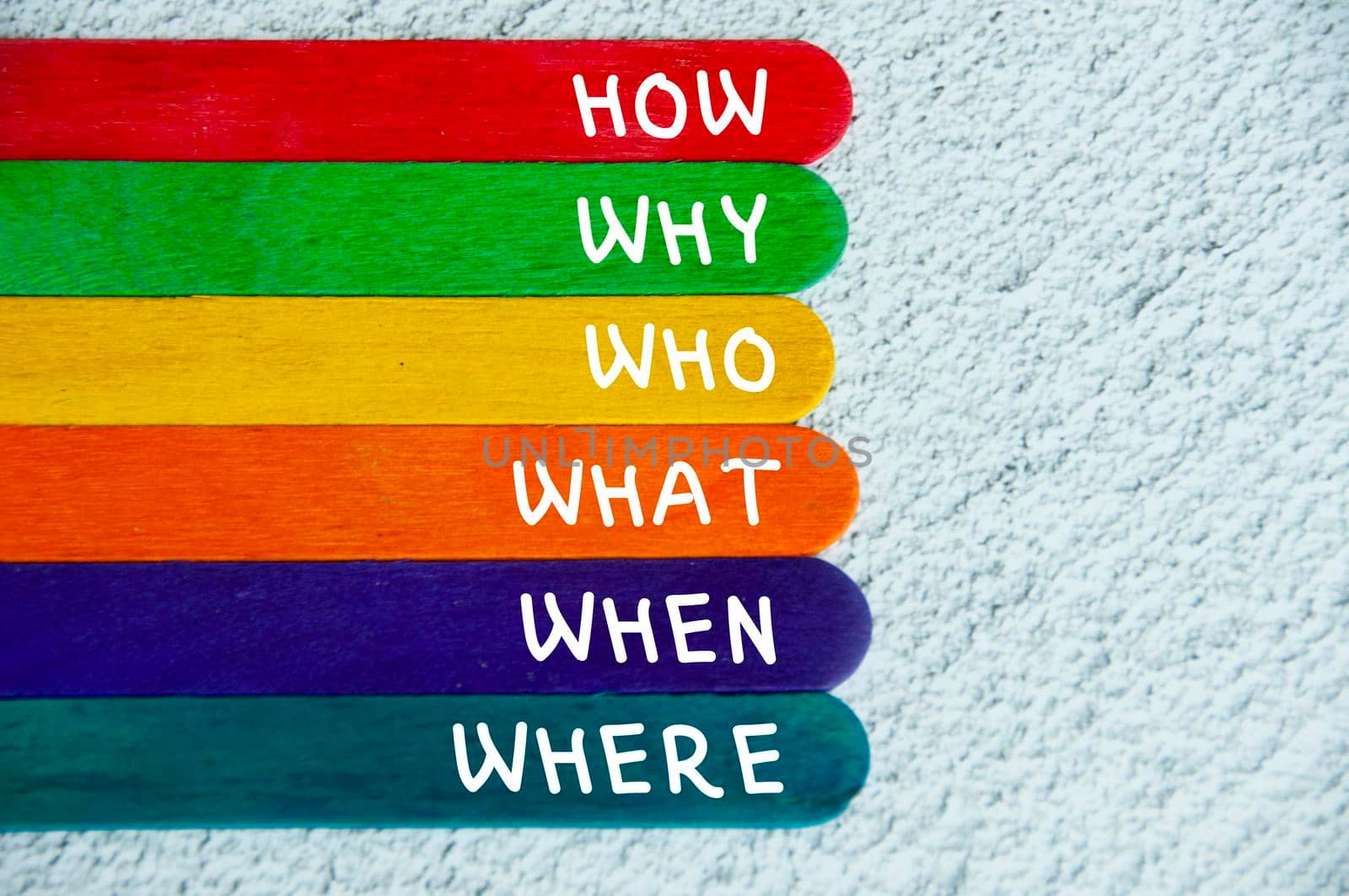 Text on wooden color sticks - How, Why, What, When, Where, Who. Fact finding concept.