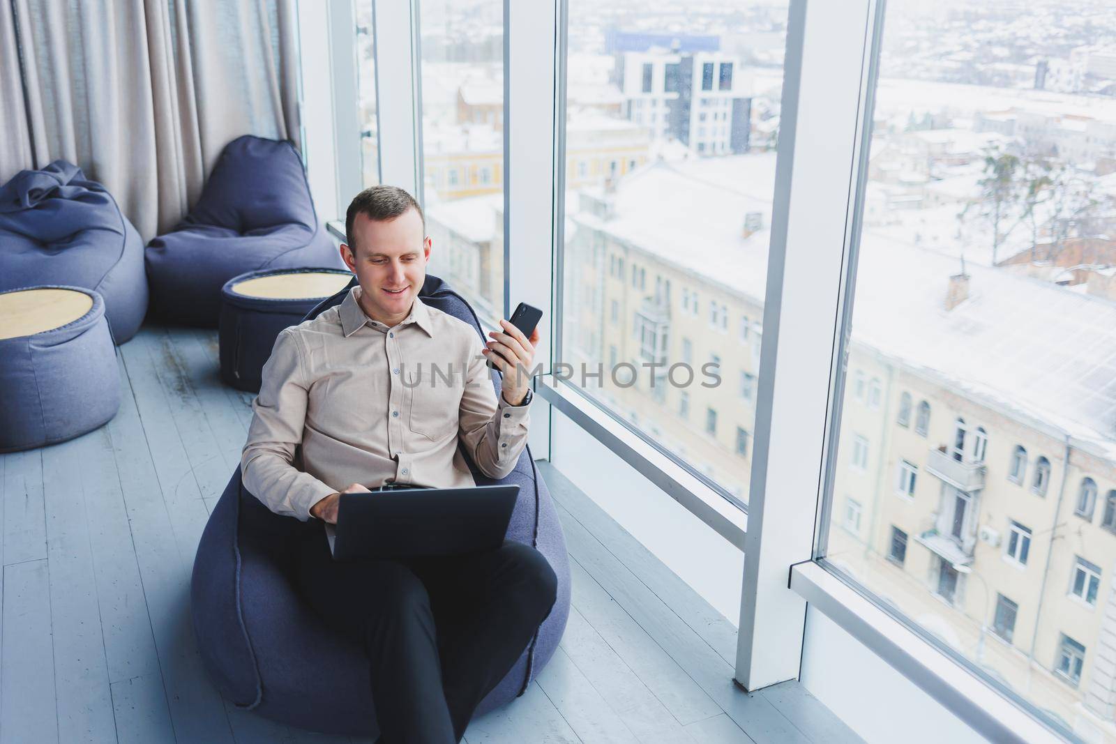 A successful businessman sits in a working cafe and works on an important project. Businessman is typing on a laptop. Businessman using laptop in cafe