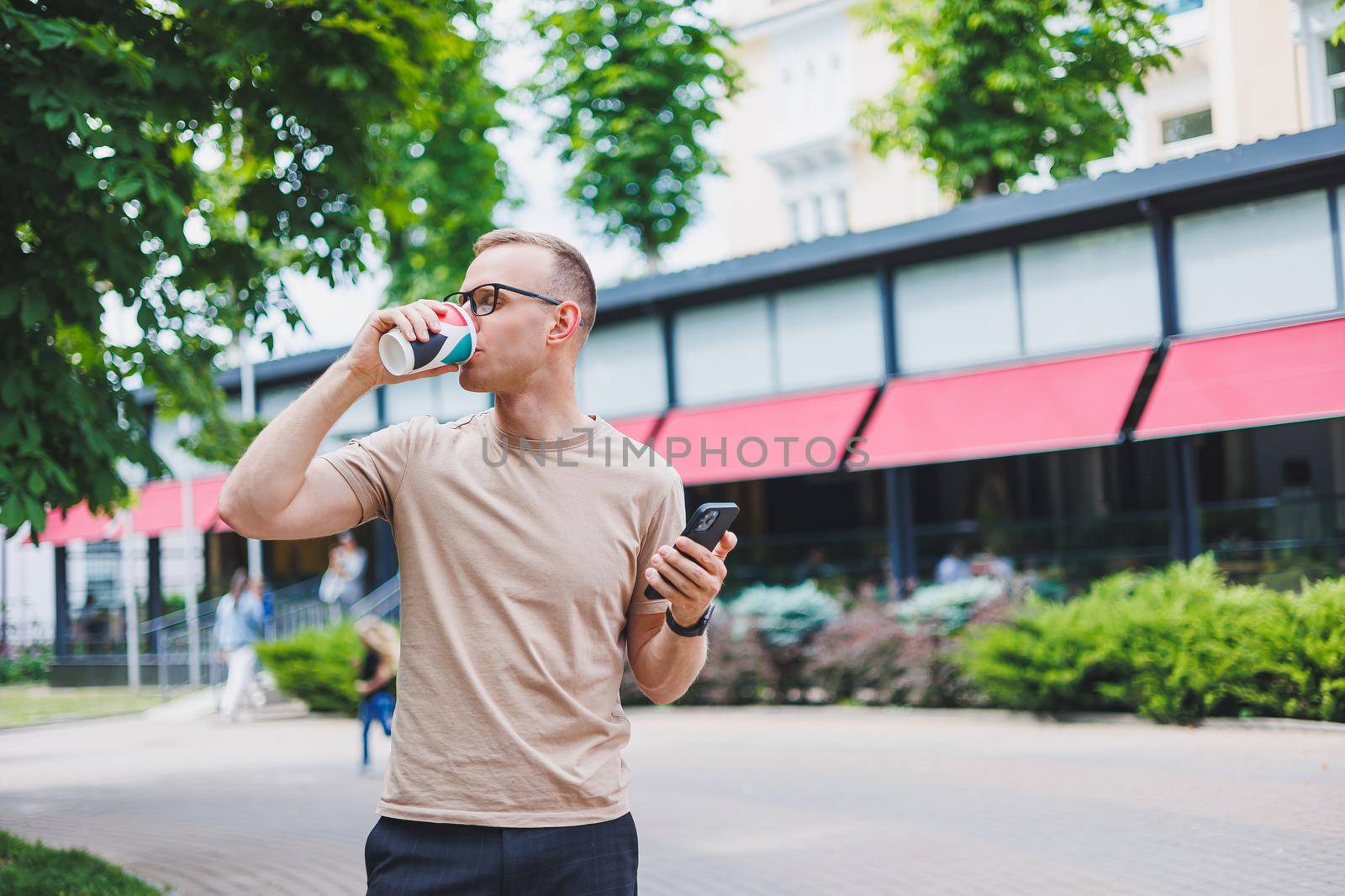 Modern businessman and business woman sitting at coffee shop and using mobile. Business people.