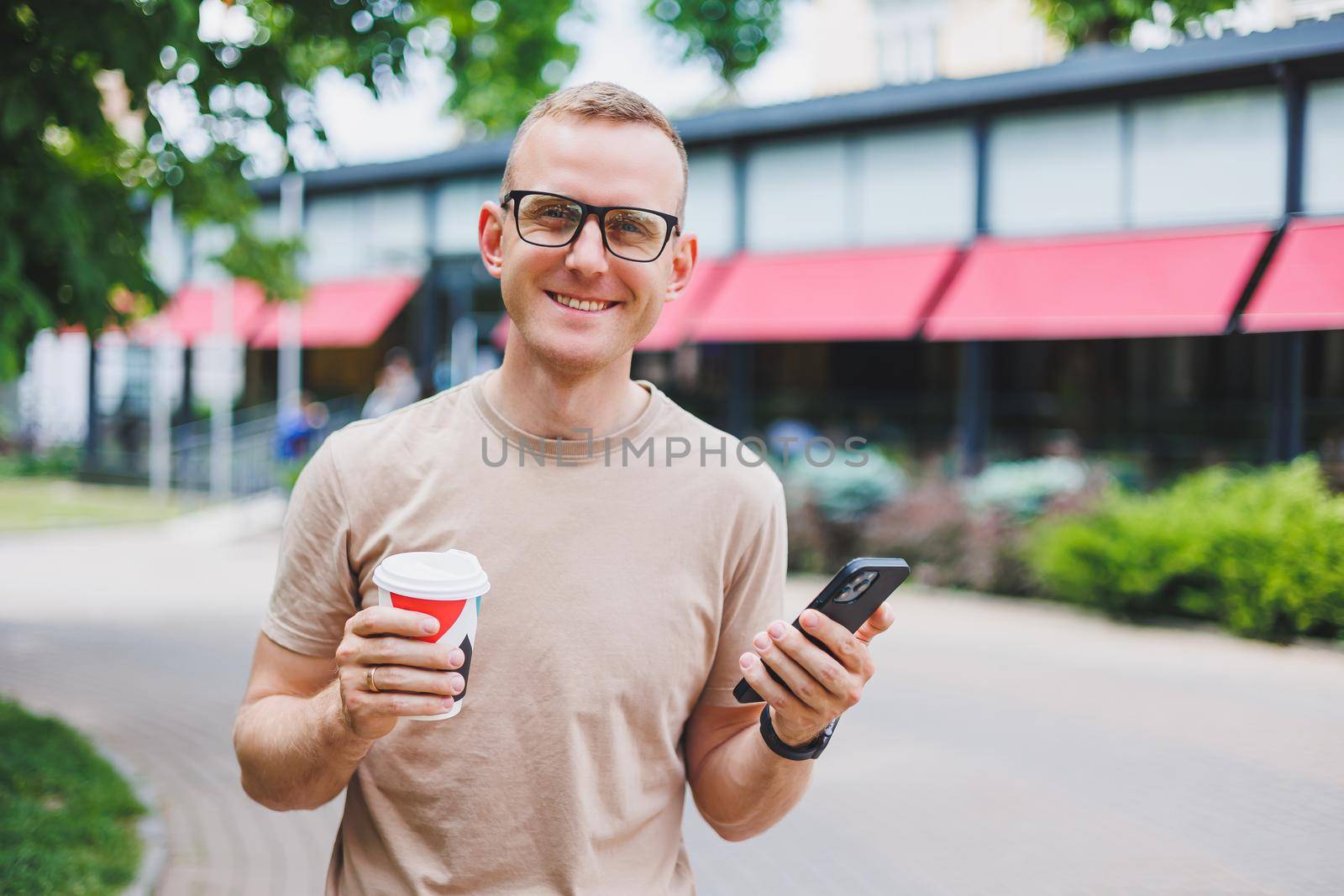 Modern businessman and business woman sitting at coffee shop and using mobile. Business people.