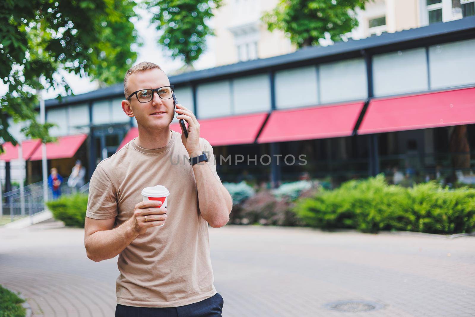 Modern businessman and business woman sitting at coffee shop and using mobile. Business people.