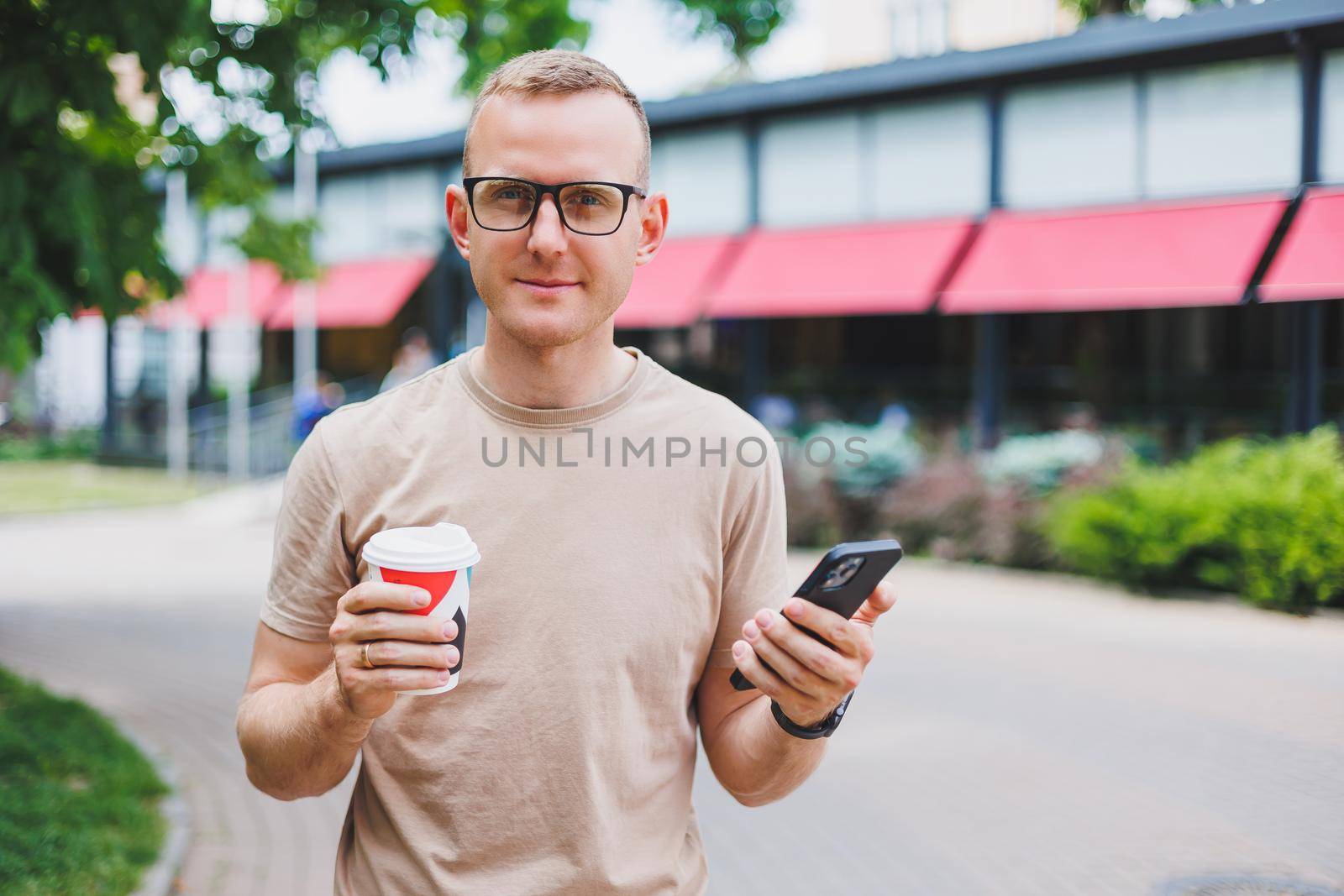 Modern businessman and business woman sitting at coffee shop and using mobile. Business people.