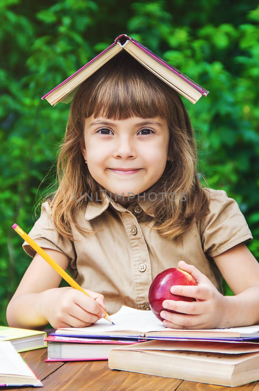 little girl student with a red apple. Selective focus. nature. by yanadjana