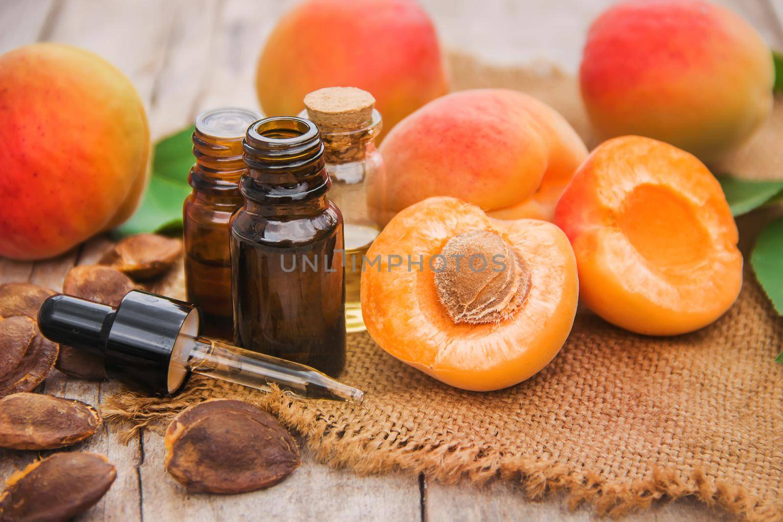 apricot oil in a small jar. selective focus. by yanadjana